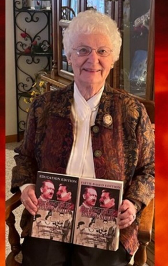 Mildred Schindler Janzen holding the education and faith-based editions of her memoir